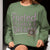 Fueled by Chalk & Dreams printed design on a vintage-style garment-dyed sweatshirt with chalkboard illustration – soft fleece ideal for teachers