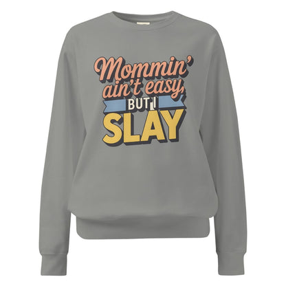 “Mommin' Ain’t Easy But I Slay” retro-style DTG printed design in peach, blue, and yellow on vintage garment-dyed fleece sweatshirt
