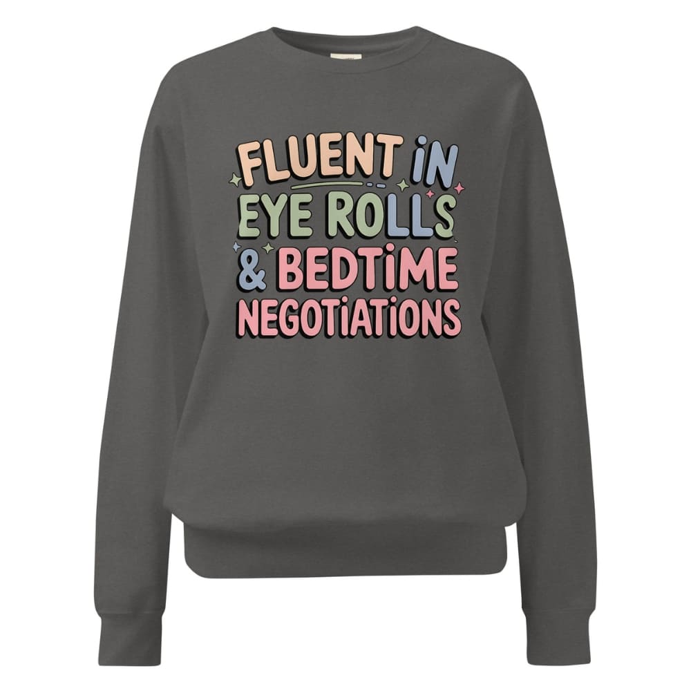 Gray sweatshirt with colorful text 'FLUENT IN EYE ROLLS & BEDTIME NEGOTIATIONS' on a white background