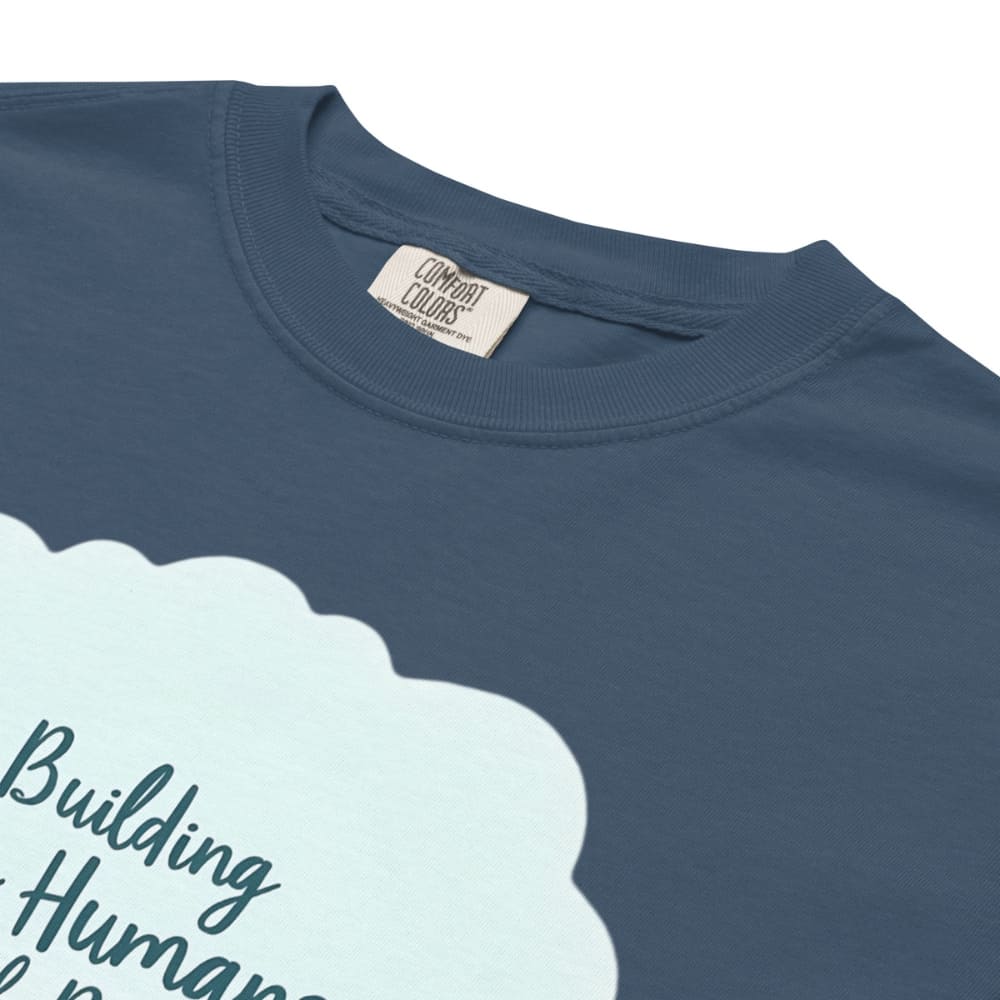 Illustrated t-shirt design with the quote "Building Tiny Humans with Big Dreams" surrounded by a family parenting scene