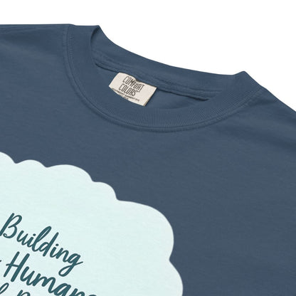 Illustrated t-shirt design with the quote "Building Tiny Humans with Big Dreams" surrounded by a family parenting scene