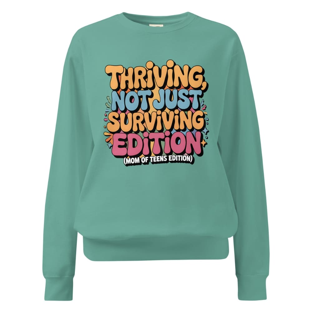 Teal sweatshirt with colorful text design on a white background