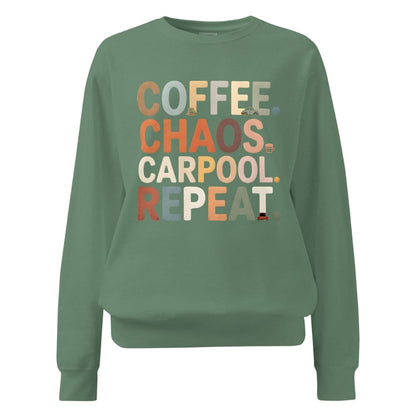 Green sweatshirt with colorful text 'COFFEE. CHAOS. CARPOOL. REPEAT.' on a white background