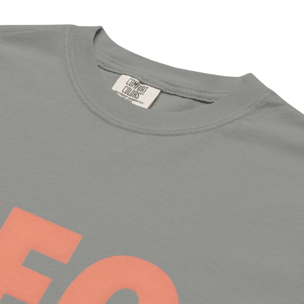 CEO of the Chaos” printed on a heavyweight cotton t-shirt in soft pastel ink, laid flat with a minimal lifestyle background.