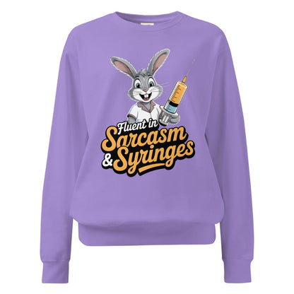Purple sweatshirt with cartoon character holding a syringe and text 'Fluent in Sarcasm & Syringes' on a white background