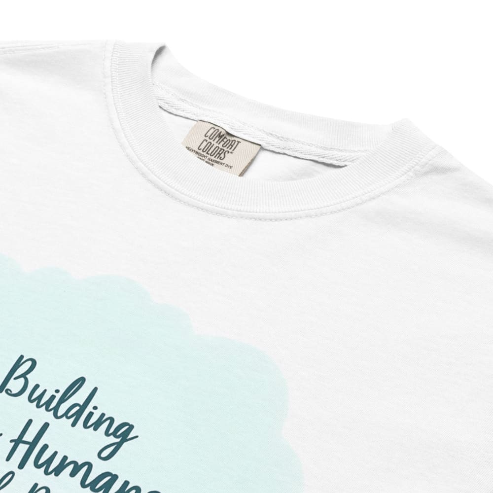 Illustrated t-shirt design with the quote "Building Tiny Humans with Big Dreams" surrounded by a family parenting scene