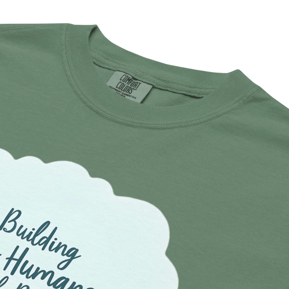 Illustrated t-shirt design with the quote "Building Tiny Humans with Big Dreams" surrounded by a family parenting scene