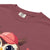 Cute cartoon owl cheerleader holding a pom-pom and clipboard, wearing a red cap with the quote “Behind Every Great Swing Is a Loud Mom” – featured on garment-dyed heavyweight cotton tee
