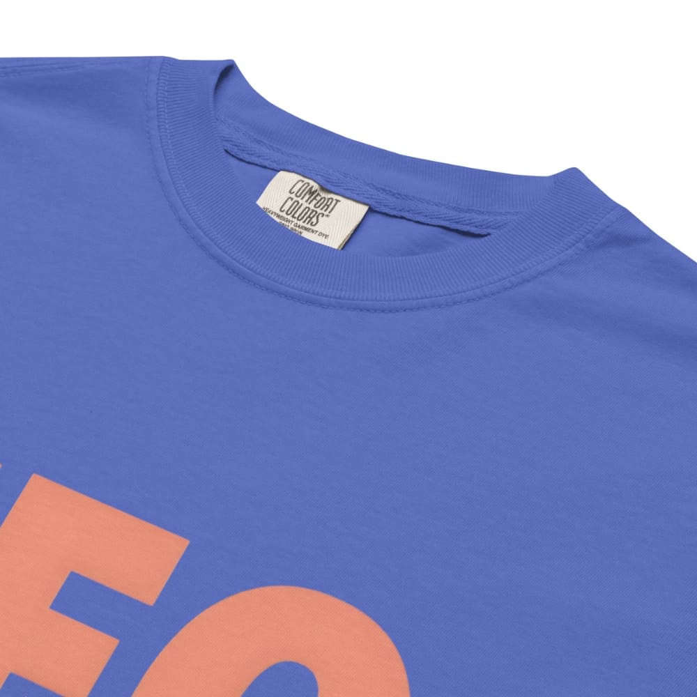 CEO of the Chaos” printed on a heavyweight cotton t-shirt in soft pastel ink, laid flat with a minimal lifestyle background.