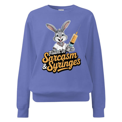 Blue sweatshirt with cartoon character and text ' Fluent in Sarcasm & Syringes' on a white background
