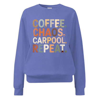 Blue sweatshirt with colorful text 'COFFEE. CHAOS. CARPOOL. REPEAT.' on a white background