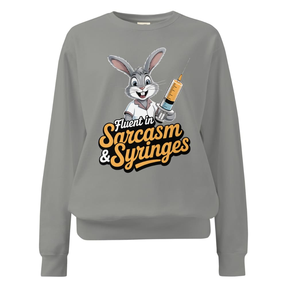 Gray sweatshirt with cartoon character and text ' Fluent in Sarcasm & Syringes' on a white background