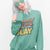 “Mommin' Ain’t Easy But I Slay” retro-style DTG printed design in peach, blue, and yellow on vintage garment-dyed fleece sweatshirt