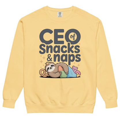 "CEO of Snacks & Naps" printed sweatshirt featuring a sloth in a crown surrounded by pretzels and plushies on vintage-washed cotton fleece