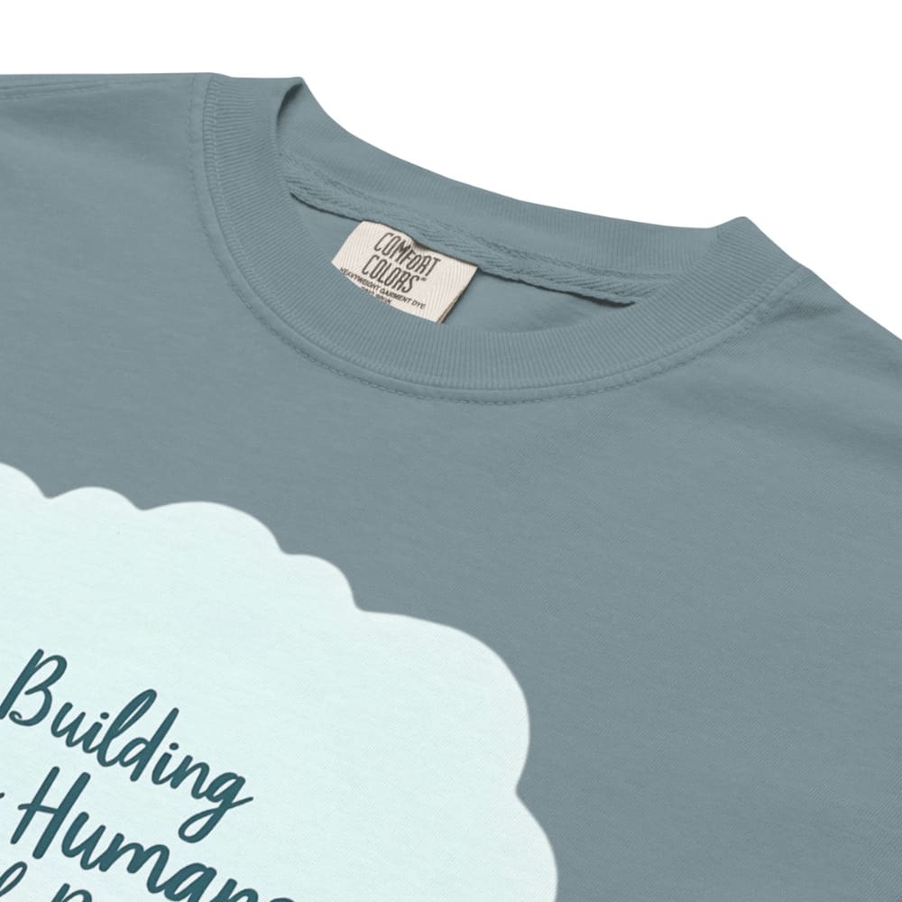 Illustrated t-shirt design with the quote "Building Tiny Humans with Big Dreams" surrounded by a family parenting scene