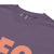 CEO of the Chaos” printed on a heavyweight cotton t-shirt in soft pastel ink, laid flat with a minimal lifestyle background.