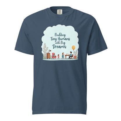 Illustrated t-shirt design with the quote "Building Tiny Humans with Big Dreams" surrounded by a family parenting scene