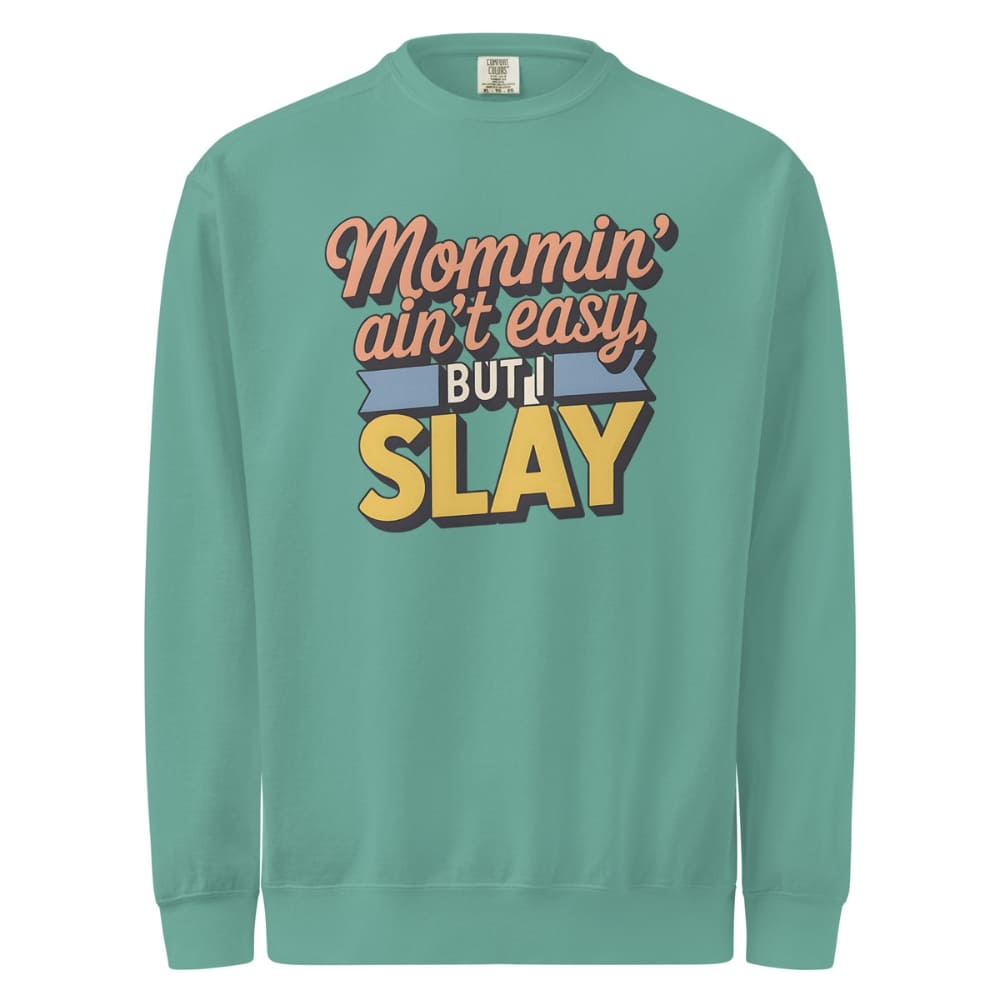“Mommin' Ain’t Easy But I Slay” retro-style DTG printed design in peach, blue, and yellow on vintage garment-dyed fleece sweatshirt