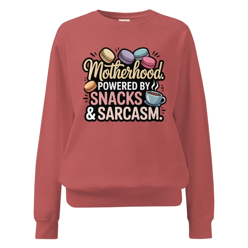 Sweatshirt design with text “Motherhood. Powered by Snacks & Sarcasm.” featuring colorful macarons and a steaming coffee cup on vintage-washed cotton fleece.