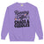Purple sweatshirt with text 'Running on Coffee, Chaos & Cuddles' on a white background