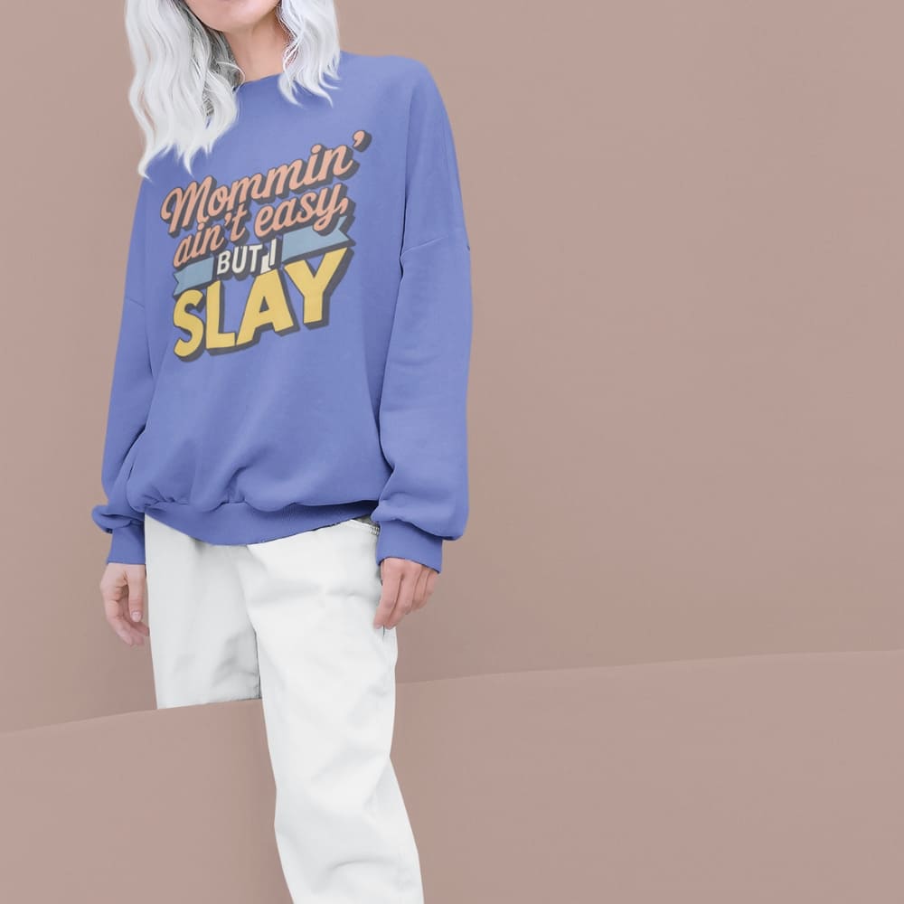 “Mommin' Ain’t Easy But I Slay” retro-style DTG printed design in peach, blue, and yellow on vintage garment-dyed fleece sweatshirt