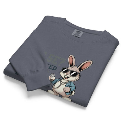 Folded gray sweatshirt with a cartoon rabbit design on a white background