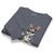 Folded gray sweatshirt with a cartoon rabbit design on a white background