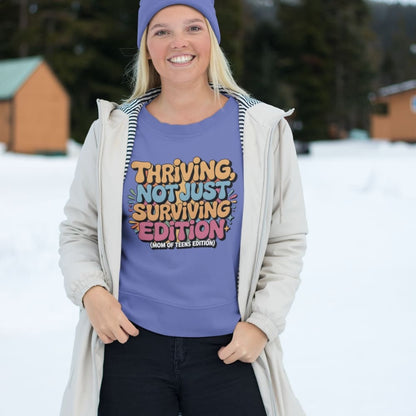 Person wearing a purple sweater with colorful text in a snowy outdoor setting