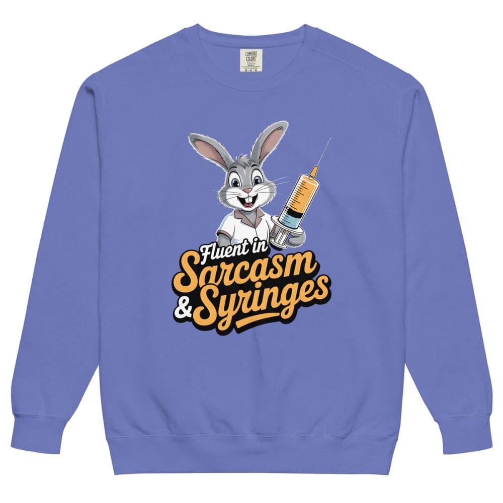Blue sweatshirt with cartoon character holding a syringe and text 'Fluent in Sarcasm & Syringes' on a white background
