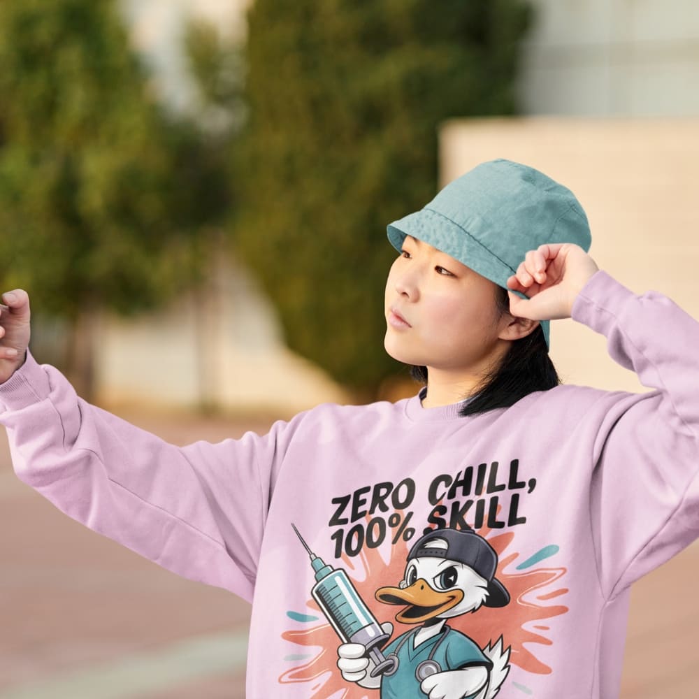 Child wearing a pink sweatshirt with a cartoon character and text, outdoors.