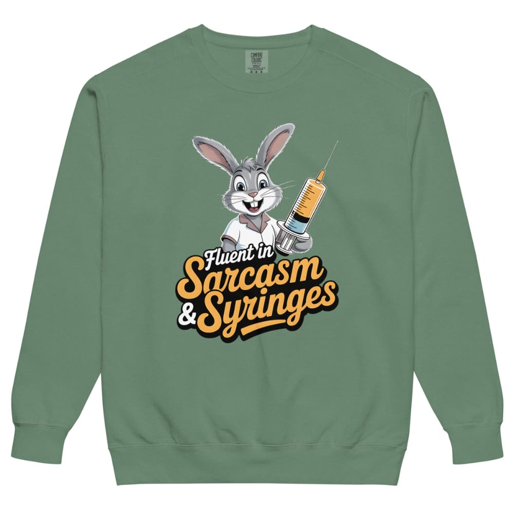 Green sweatshirt with cartoon character holding a syringe and text 'Fluent in Sarcasm & Syringes' on a white background