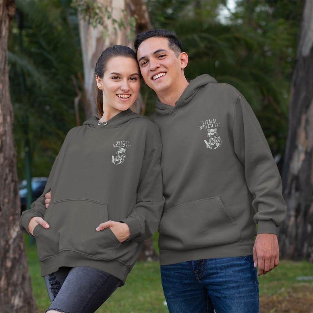 Raccoon nurse graphic wearing scrubs and sunglasses holding a clipboard under the quote “Vitals? Nailed It.” – printed on a black Cotton Heritage hoodie