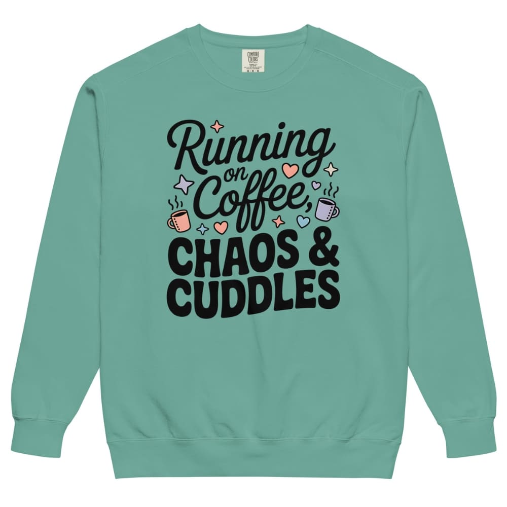 Teal sweatshirt with text 'Running on Coffee, Chaos & Cuddles' on a white background
