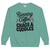 Teal sweatshirt with text 'Running on Coffee, Chaos & Cuddles' on a white background