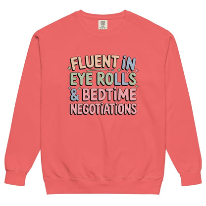 Coral sweatshirt with colorful text on a white background