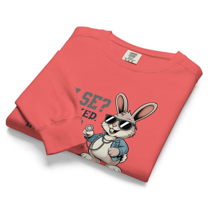 Folded red sweatshirt with cartoon rabbit design and text on a white background