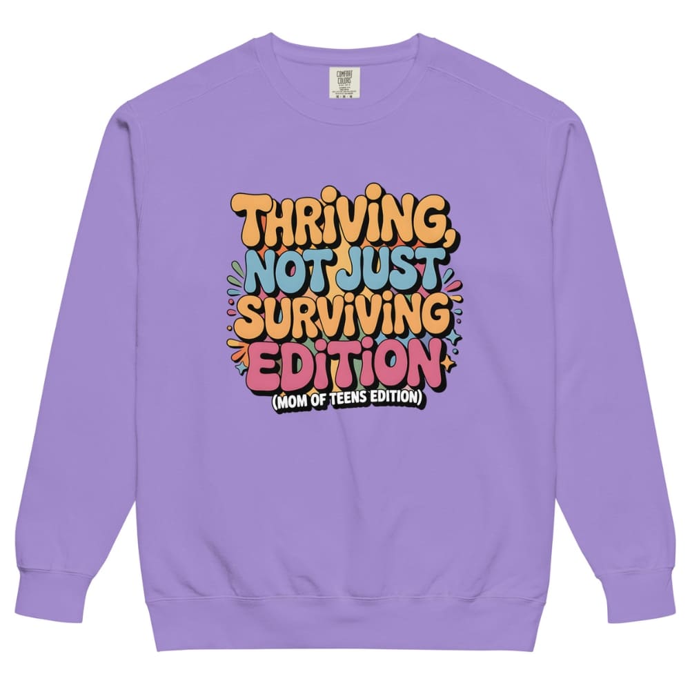 Purple sweatshirt with colorful text design on a white background