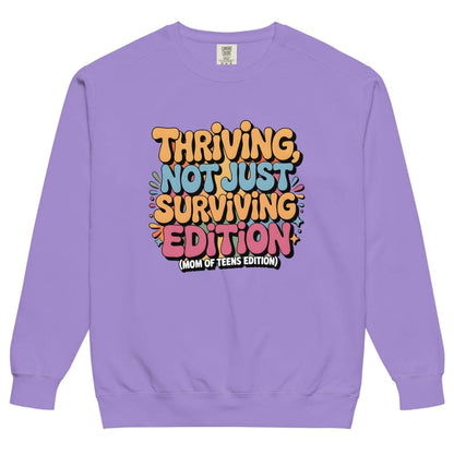 Purple sweatshirt with colorful text design on a white background