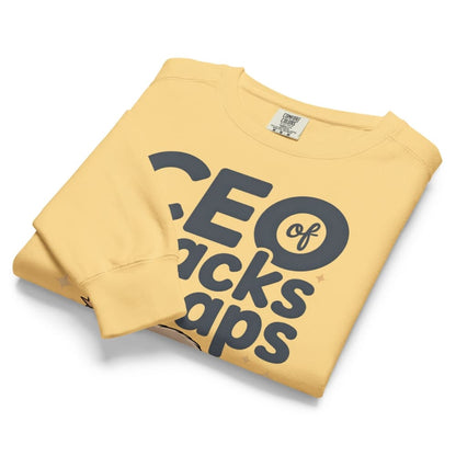 "CEO of Snacks & Naps" printed sweatshirt featuring a sloth in a crown surrounded by pretzels and plushies on vintage-washed cotton fleece