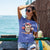 Cute cartoon owl cheerleader holding a pom-pom and clipboard, wearing a red cap with the quote “Behind Every Great Swing Is a Loud Mom” – featured on garment-dyed heavyweight cotton tee
