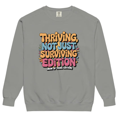 Gray sweatshirt with colorful text design on a white background
