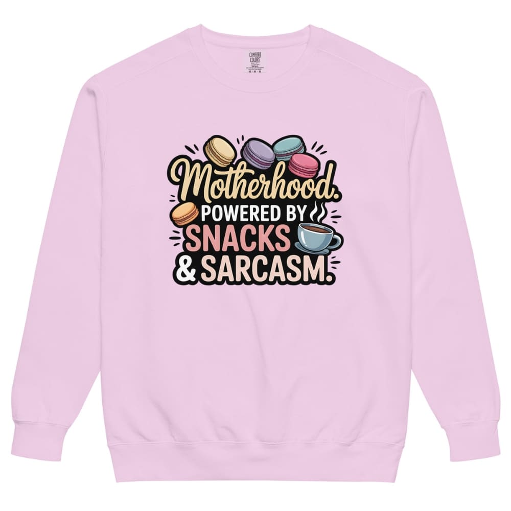 Sweatshirt design with text “Motherhood. Powered by Snacks & Sarcasm.” featuring colorful macarons and a steaming coffee cup on vintage-washed cotton fleece.