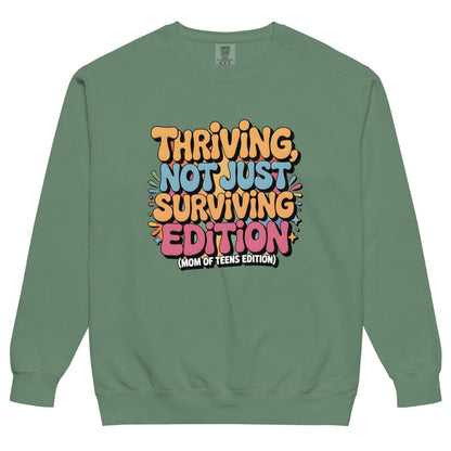 Green sweatshirt with colorful text design on a white background