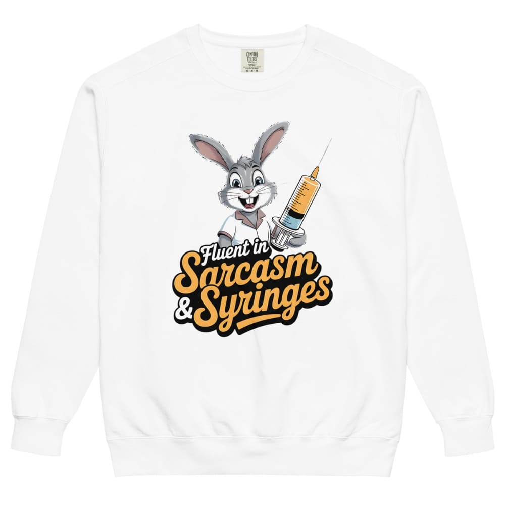 White sweatshirt with cartoon character holding a syringe and text 'Fluent in Sarcasm & Syringes' on a white background
