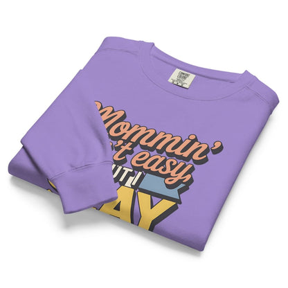 “Mommin' Ain’t Easy But I Slay” retro-style DTG printed design in peach, blue, and yellow on vintage garment-dyed fleece sweatshirt