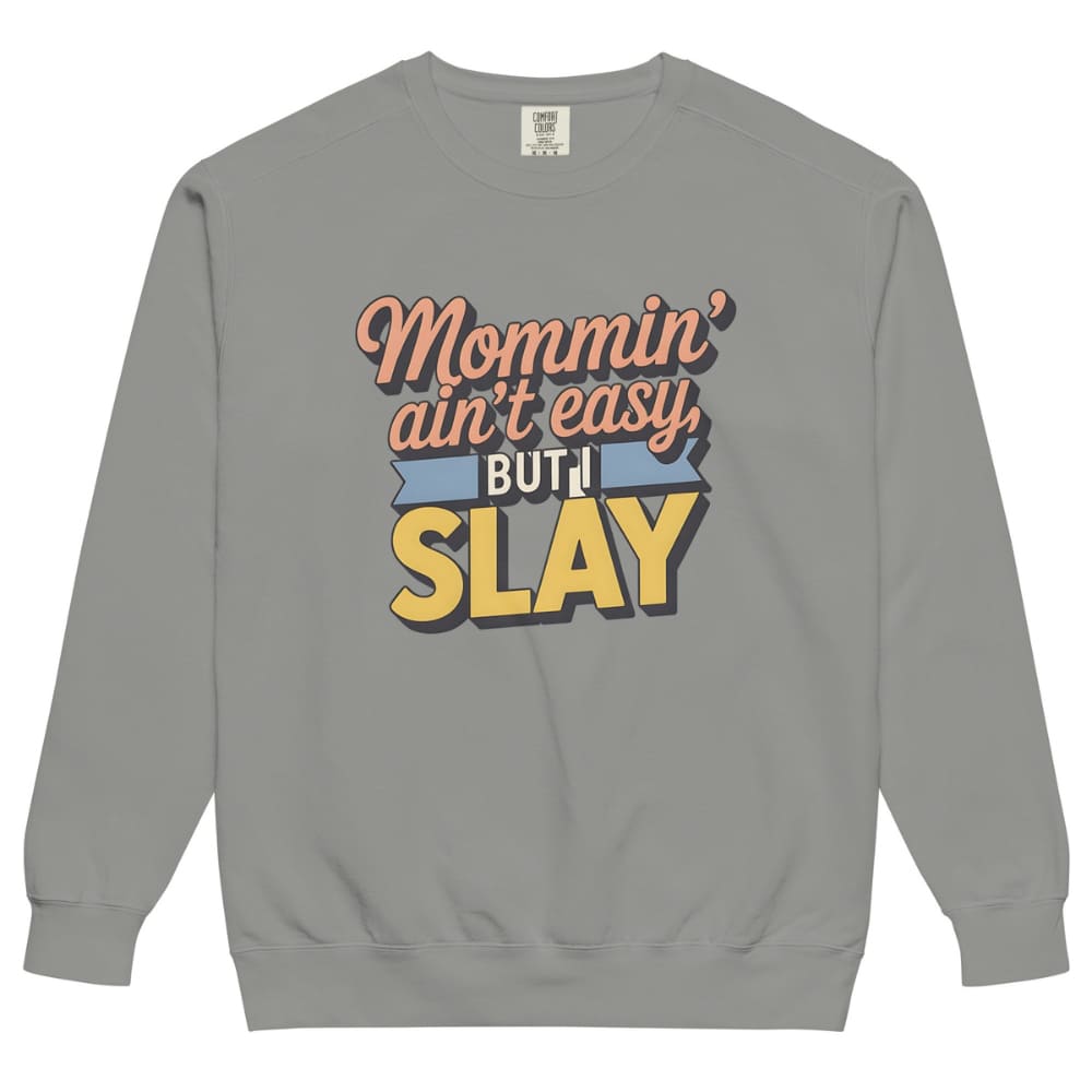 “Mommin' Ain’t Easy But I Slay” retro-style DTG printed design in peach, blue, and yellow on vintage garment-dyed fleece sweatshirt