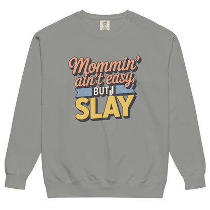 “Mommin' Ain’t Easy But I Slay” retro-style DTG printed design in peach, blue, and yellow on vintage garment-dyed fleece sweatshirt