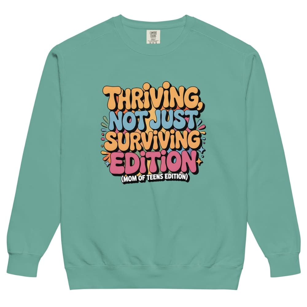 Teal sweatshirt with colorful text design on a white background