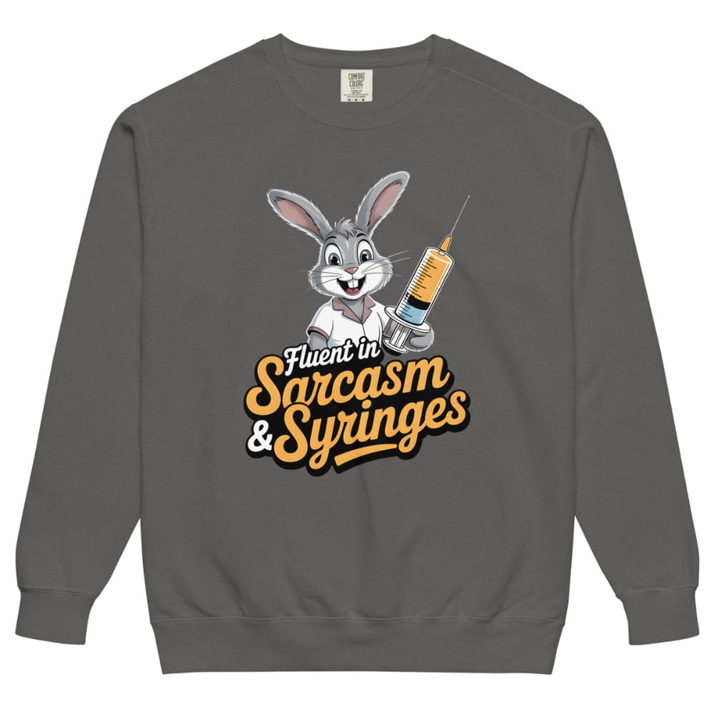 Gray sweatshirt with cartoon character holding a syringe and text ' Fluent in Sarcasm & Syringes' on a white background