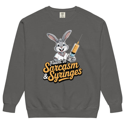 Gray sweatshirt with cartoon character holding a syringe and text ' Fluent in Sarcasm & Syringes' on a white background
